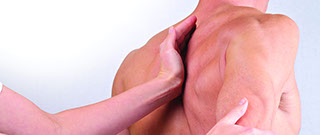 image of a mans back with a massage therapists hand applied to the shoulderblade